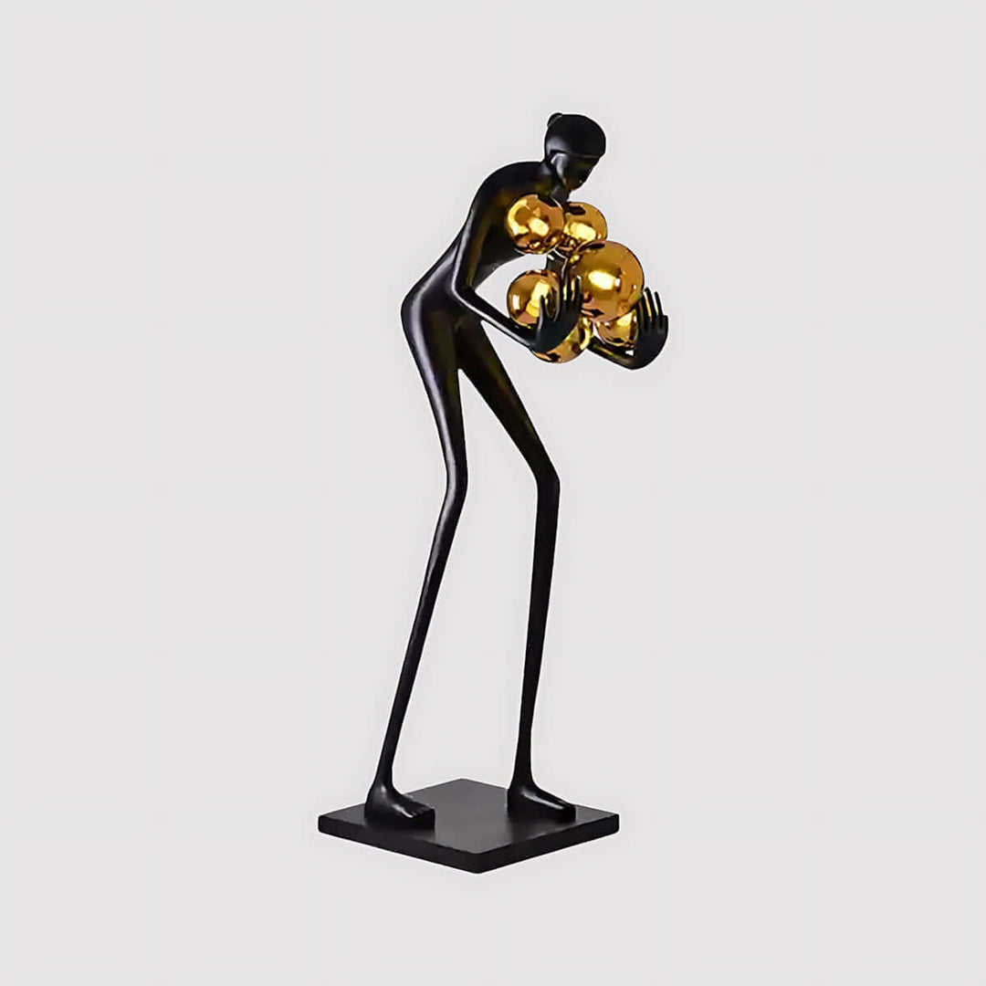 Art Deco resin sculpture of a tall figure holding golden orbs, perfect for living room decorations.
