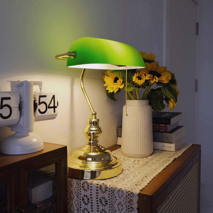 Vintage bankers table lamp with green shade and pull chain, perfect for traditional and office settings.