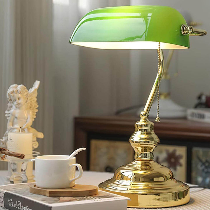 Vintage bankers table lamp with a green shade and gold base, perfect for office or traditional table settings.