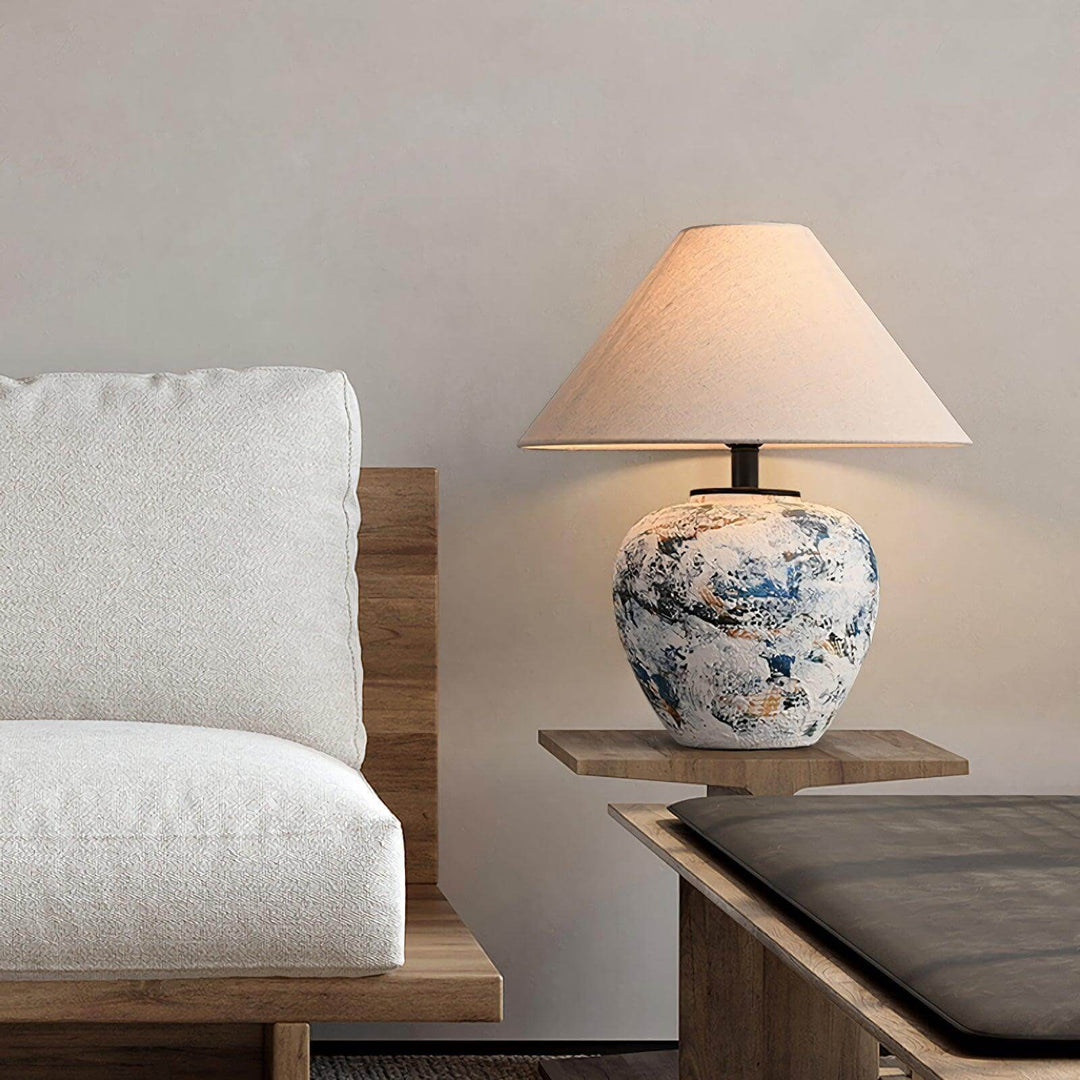 Neoclassical ceramic table lamp on a wooden side table next to a white sofa, perfect for living room decor.