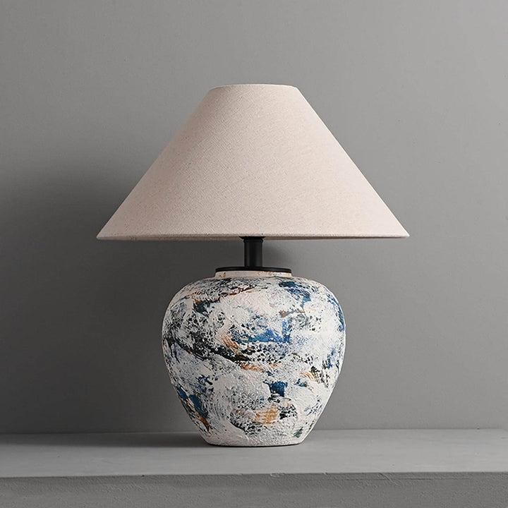 Neoclassical ceramic table lamp with a textured vase base and beige shade, perfect for living room or farmhouse decor.