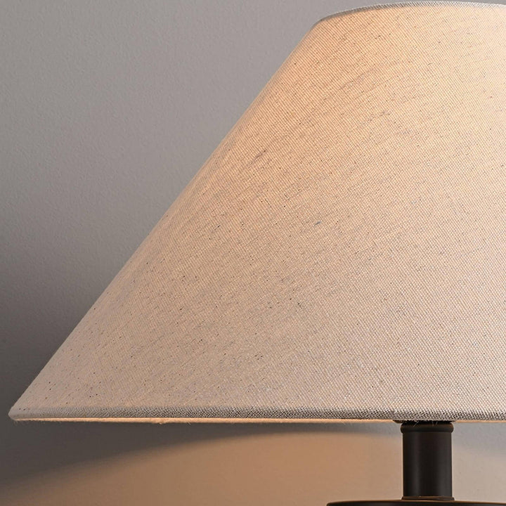 Close-up of a soft, beige lampshade illuminating, perfect for ceramic table lamps in a living room or farmhouse decor.