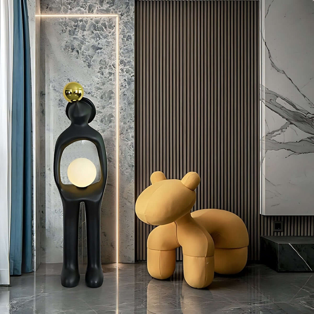 Sculptural art deco floor lamp next to a cute yellow bear-shaped chair in a modern living room interior.