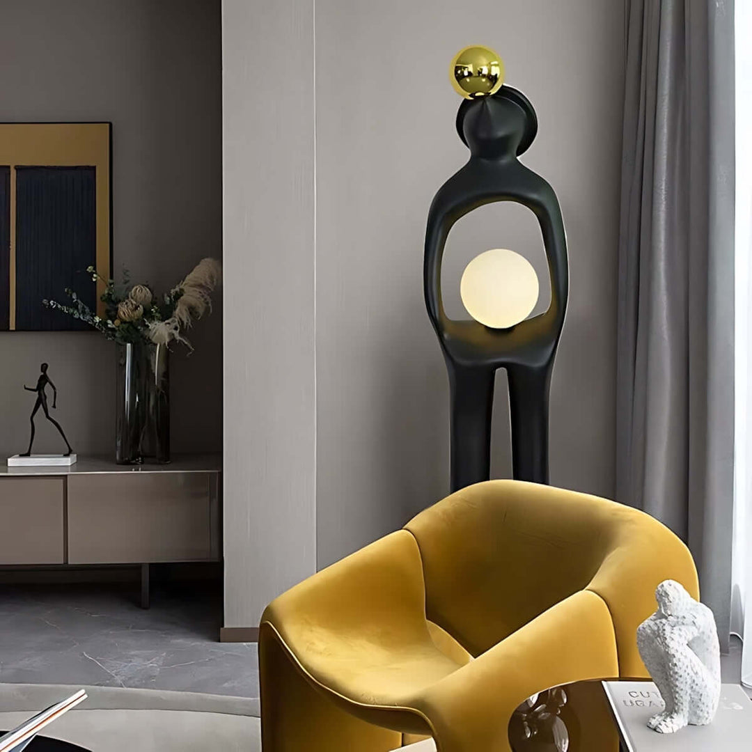 Sculptural art deco floor lamp in stylish living room, enhancing decor with modern design and warm lighting.