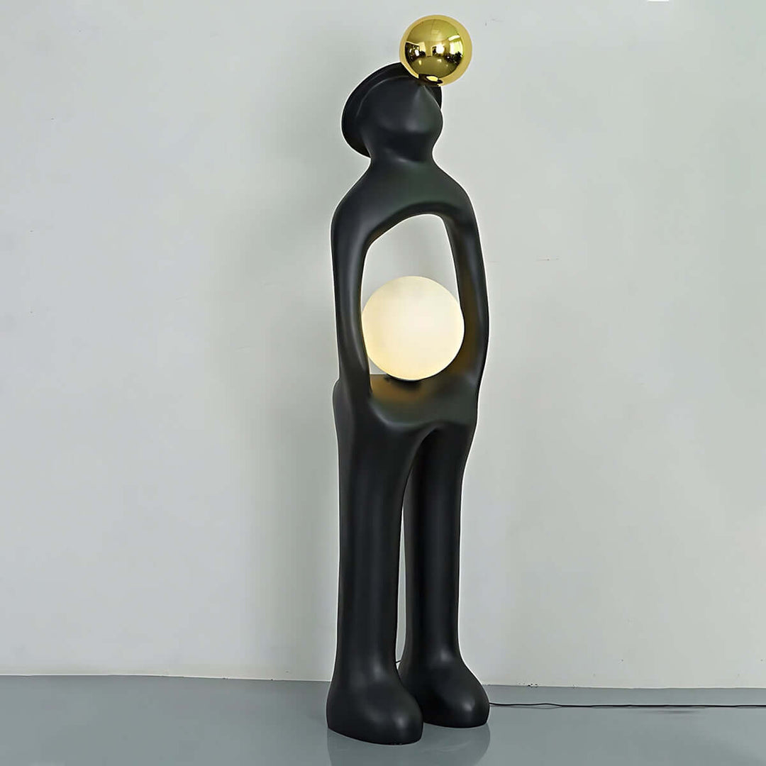 Voreli sculptural floor lamp in black with golden accent, a stylish art deco light for living room.