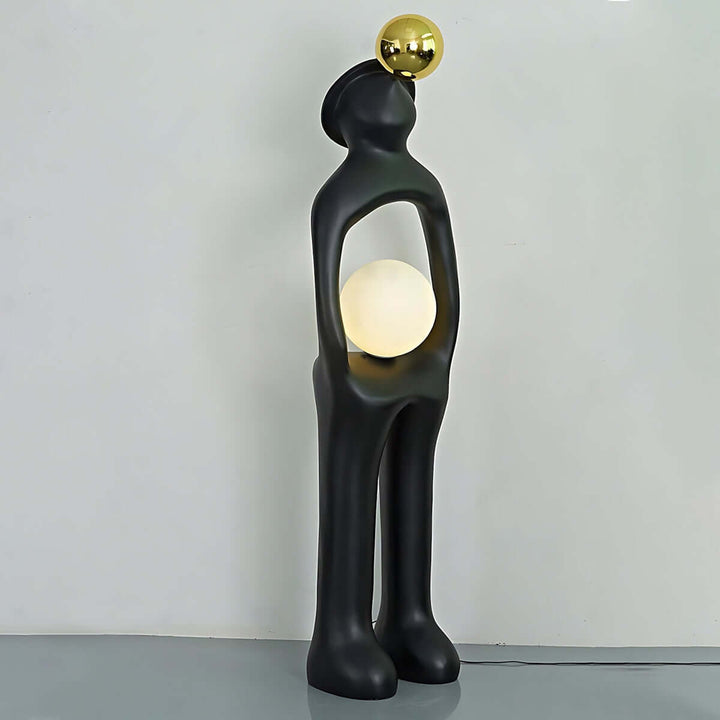 Voreli sculptural floor lamp in black with golden accent, a stylish art deco light for living room.