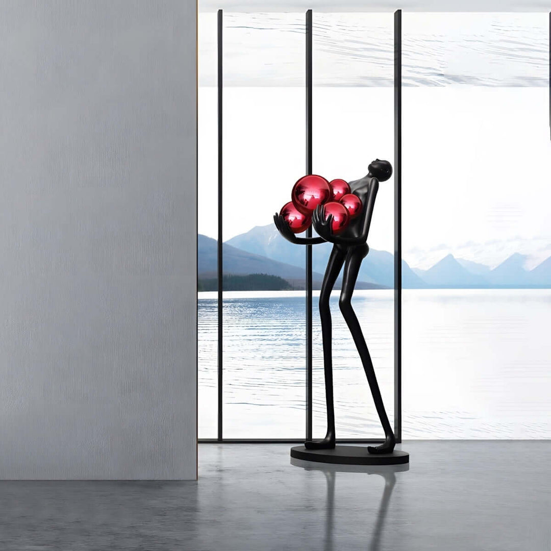 Sculptural art deco floor lamp in black, elegantly positioned by a large window with a scenic view.
