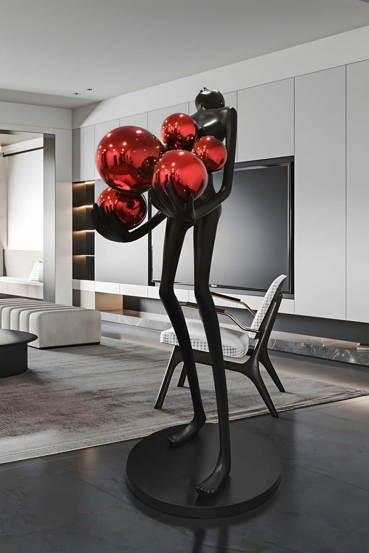 Sculptural floor lamp with red orbs, modern art deco design in a stylish living room setting.