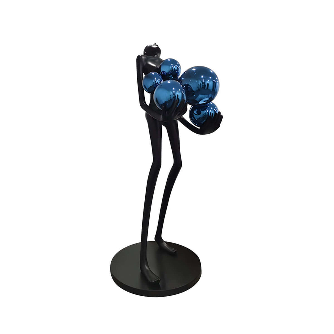 Sculptural floor lamp featuring an abstract figure holding blue decorative spheres, perfect for art deco-inspired living rooms.