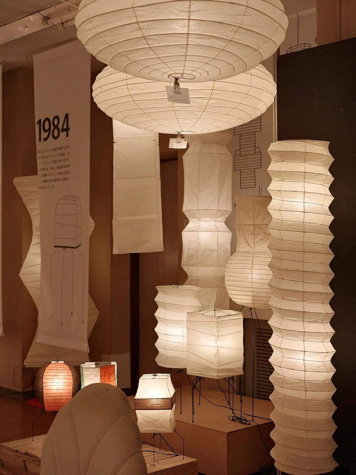 A display of various decorative Japanese paper floor lamps in soft white hues, perfect for living room lighting.