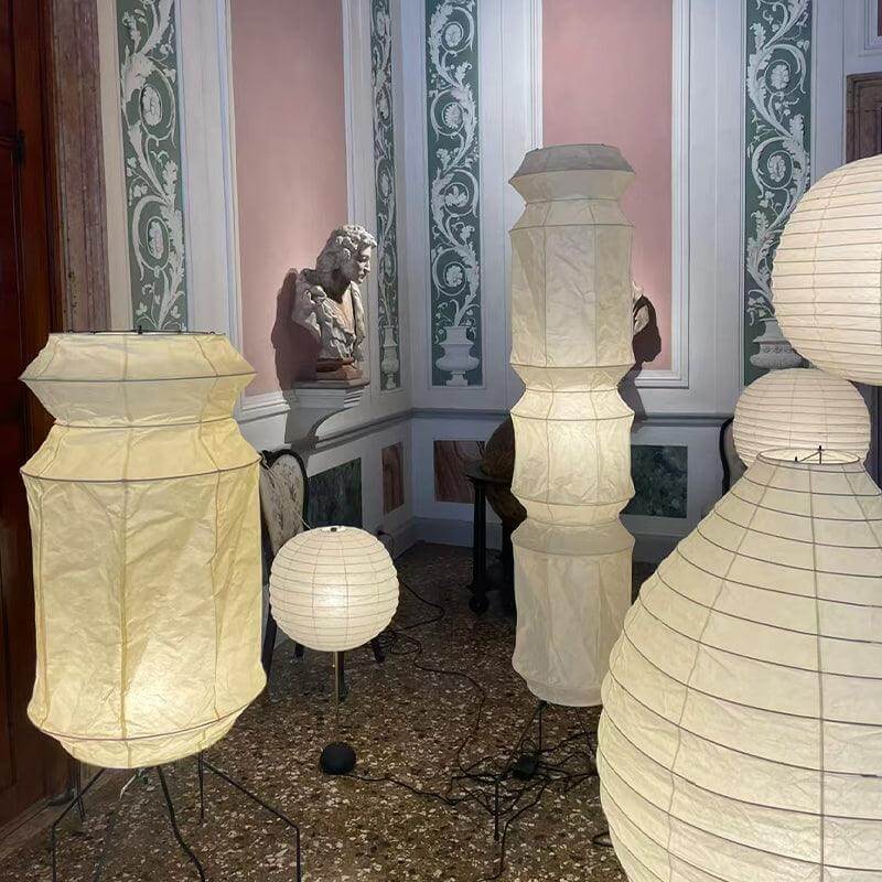 A collection of decorative washi paper floor lamps in a stylish interior, featuring various shapes and sizes.