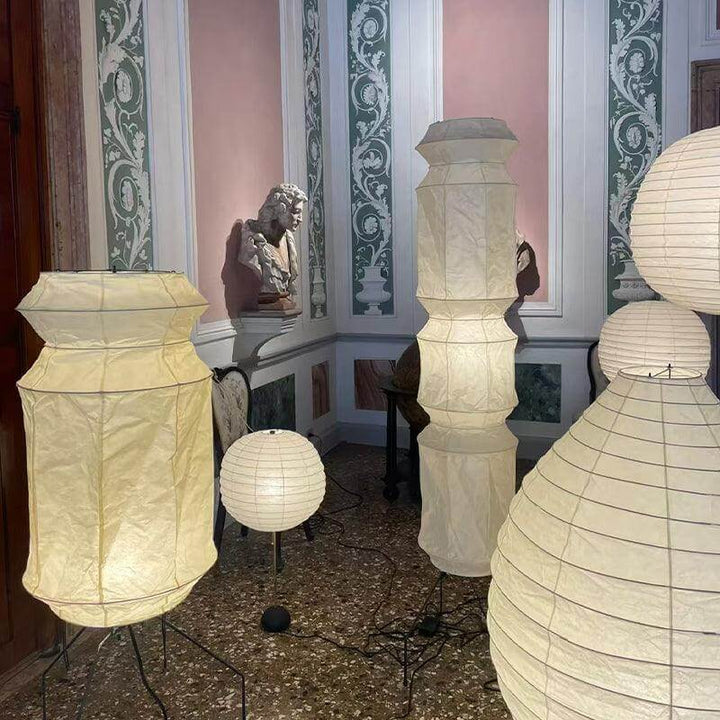 A collection of decorative washi paper floor lamps in a stylish interior, featuring various shapes and sizes.