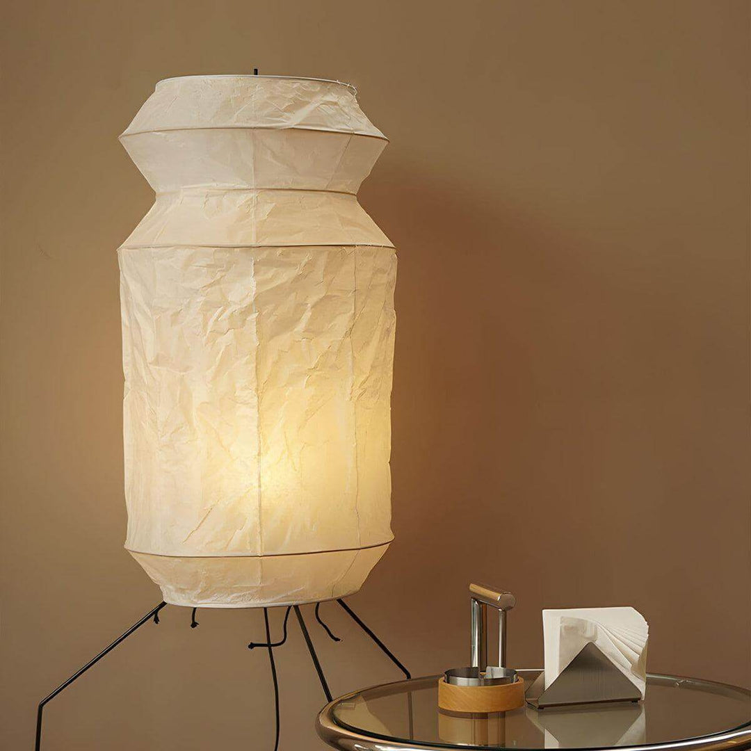 Decorative washi paper UF3-L6 floor lamp on tripod base illuminating a cozy living room, adding a touch of Japanese style.