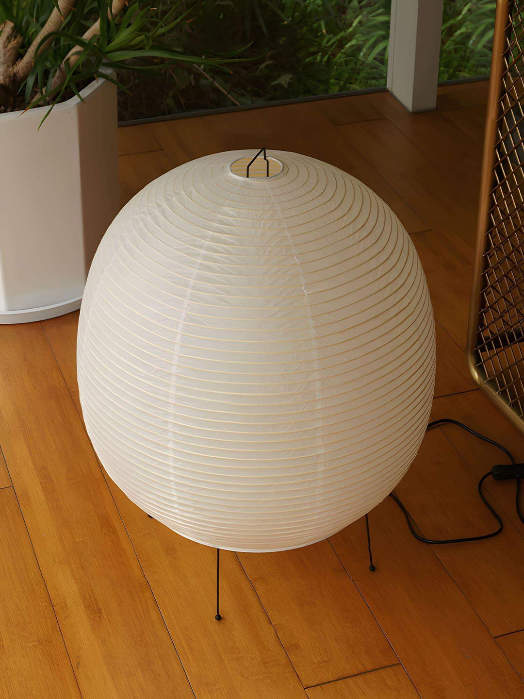 Washi Paper Bonn Table Light in round shape, ideal as a modern bedside lamp for minimalistic bedroom decor.