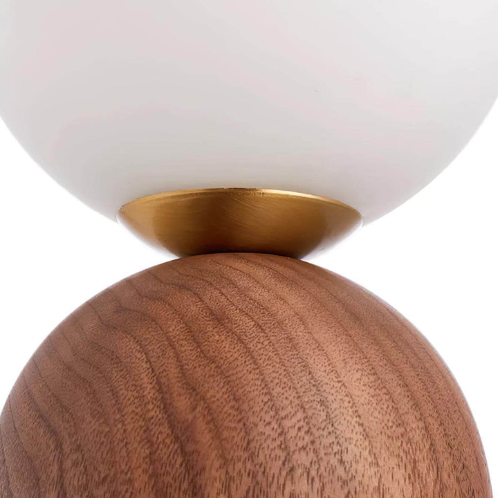 Close-up of the Wood Knuckle Table Lamp showing the wooden base, vintage milk glass globe, and elegant brass detail.
