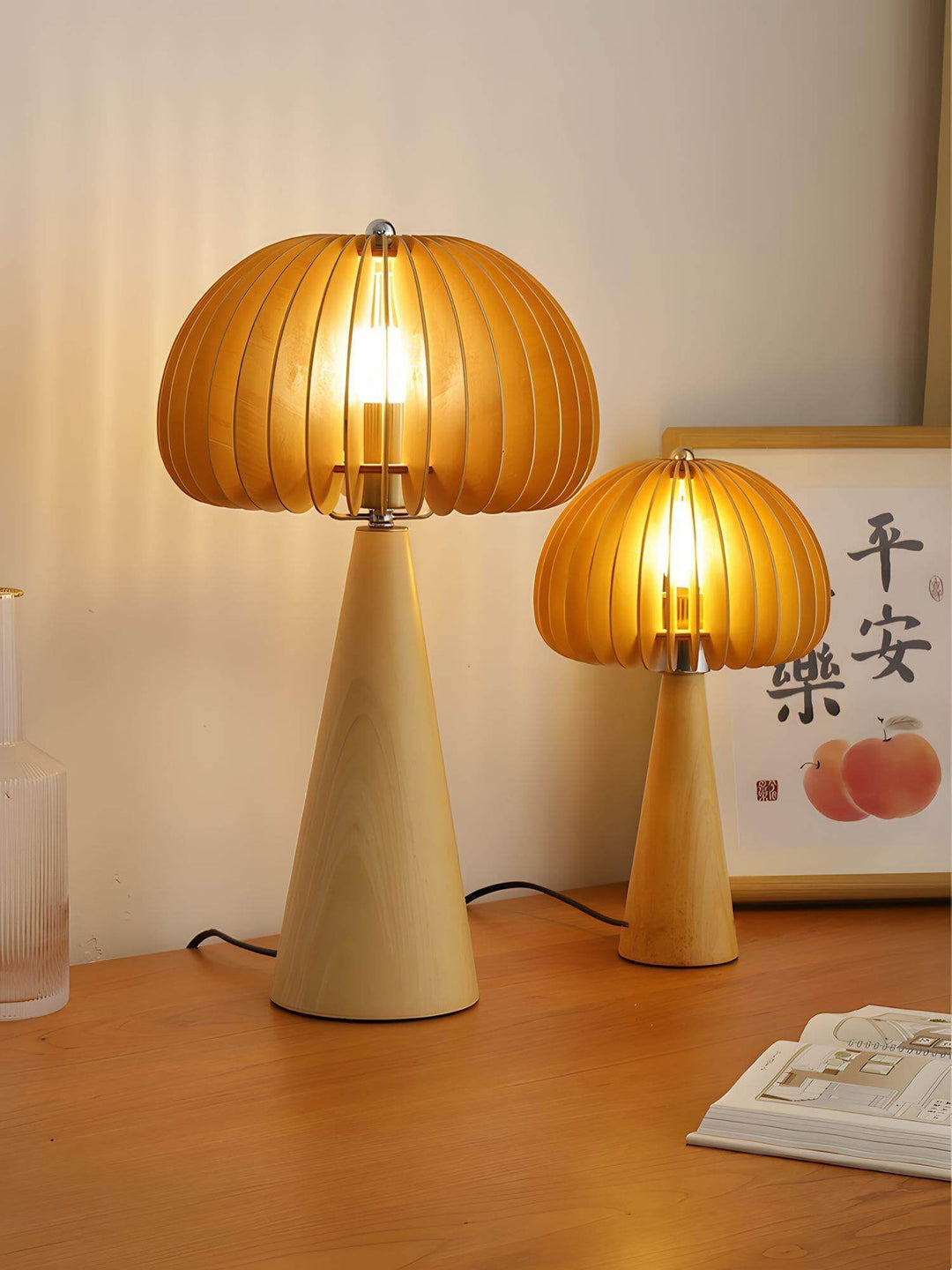 Wooden pumpkin table lamps in two sizes illuminate a cozy space with warm, inviting light. Round wood table lamps on a wooden surface.