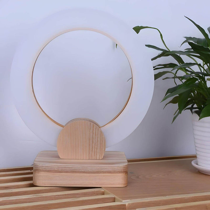 Calm Halo Table Lamp in wood, featuring a minimalistic round design perfect as a modern bedside lamp.