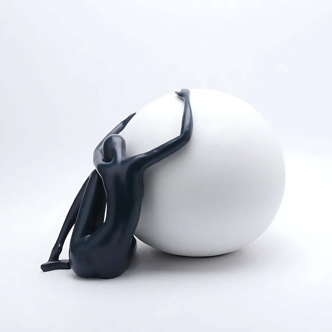 Zelvora sculpture table lamp featuring a sleek figure embracing a white sphere, ideal for art deco style living room lighting.