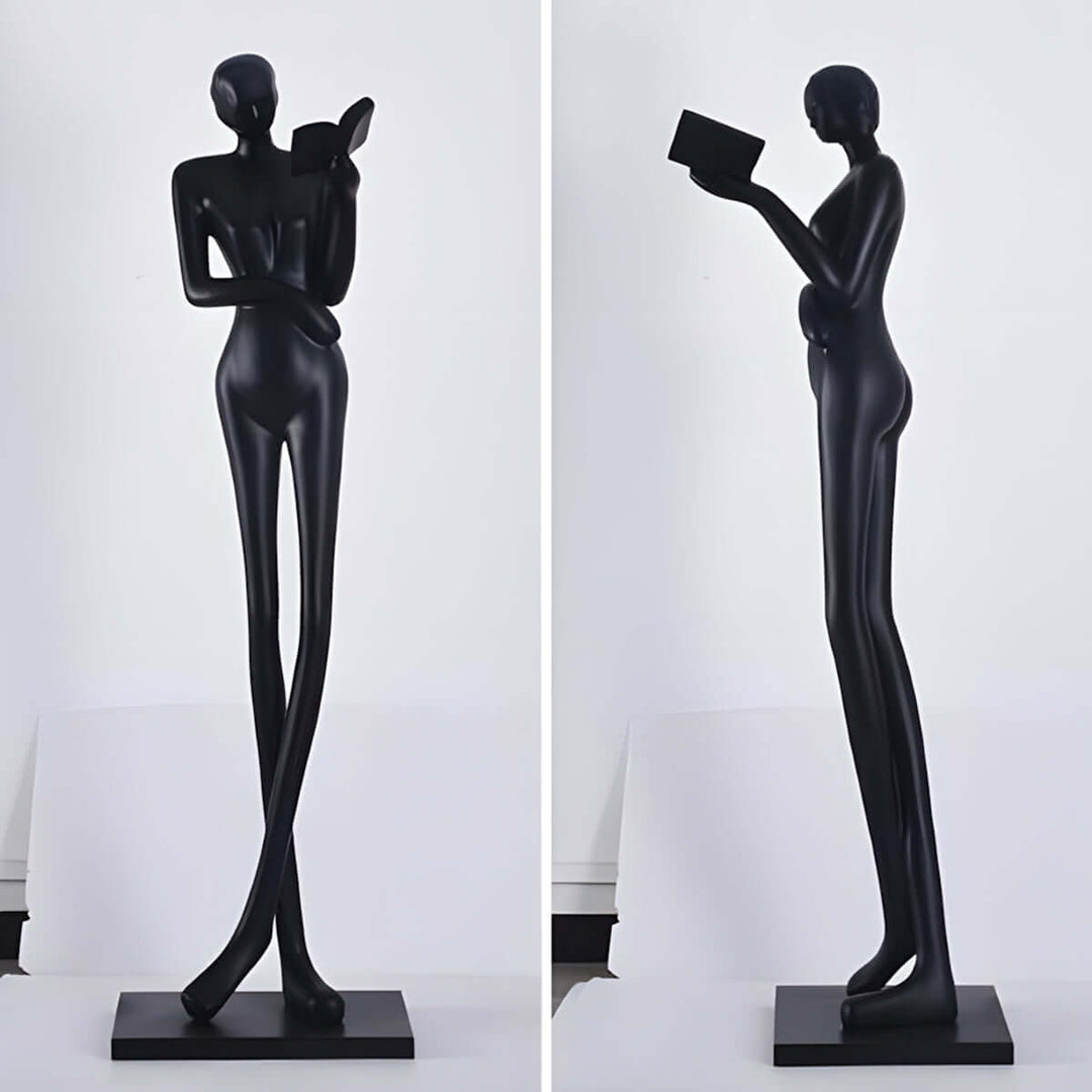 Elegant black resin sculpture of a tall figure holding a book, perfect for Art Deco living room decorations.
