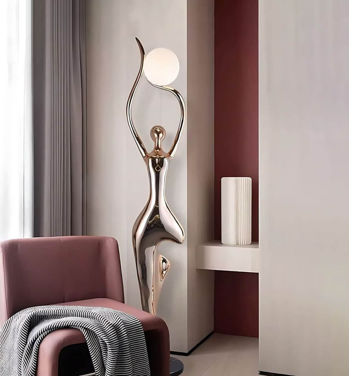 Sculptural art deco floor lamp in a modern living room corner beside a stylish armchair.