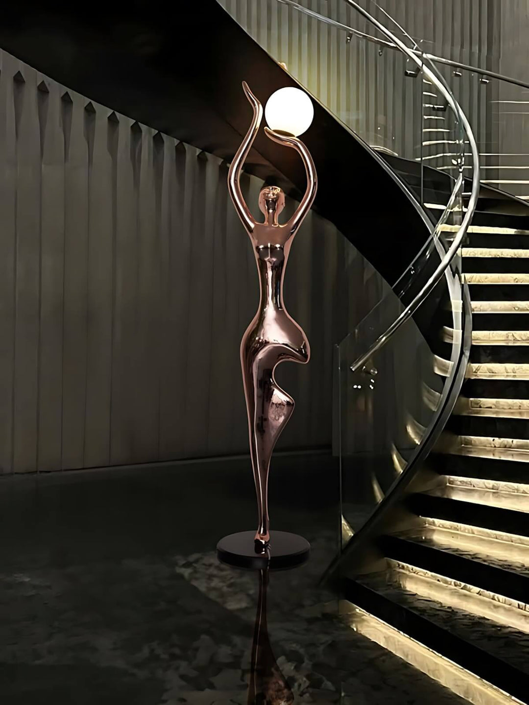 Sculptural floor lamp with art deco design illuminating a stylish staircase in a modern living room.