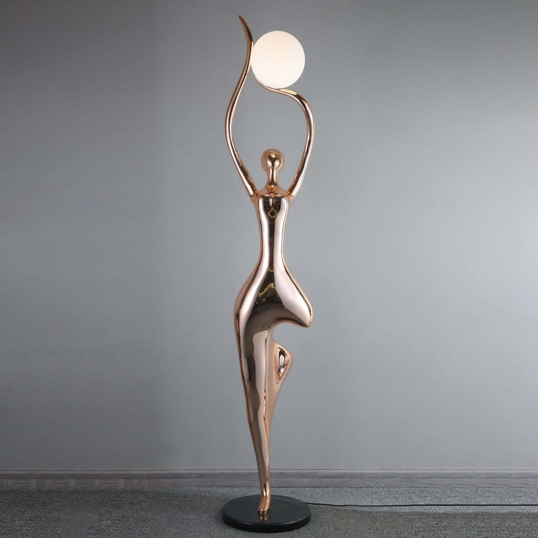 Sculptural floor lamp with art deco design, featuring a graceful figure and round light, perfect for living room decor.