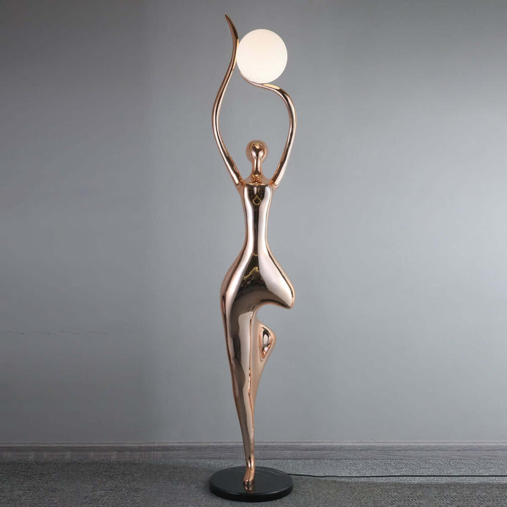 Sculptural floor lamp with art deco design, featuring a graceful figure and round light, perfect for living room decor.