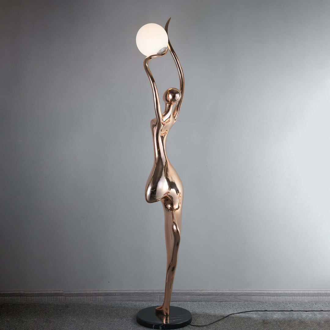 Sculptural art deco floor lamp featuring a graceful figure holding a round light, perfect for living room decor.