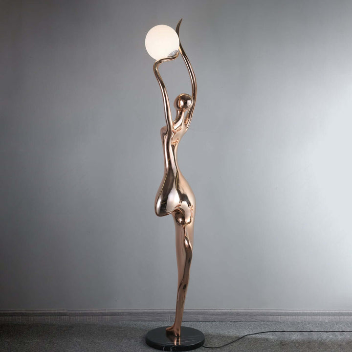 Sculptural art deco floor lamp featuring a graceful figure holding a round light, perfect for living room decor.