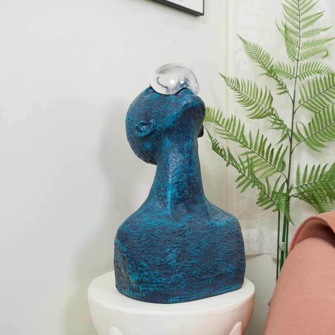 Zoreva resin sculpture in blue, featuring a unique design with a glass orb, perfect for living room decor and Art Deco style.