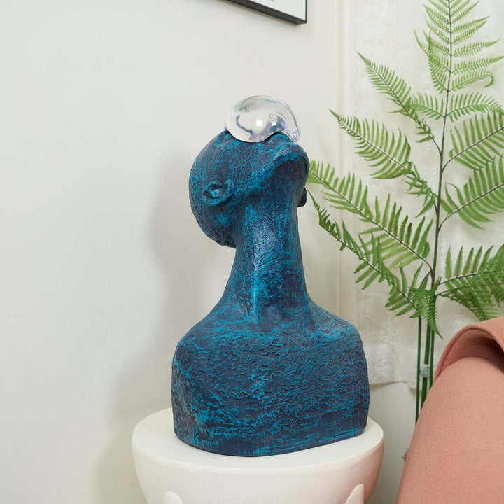 Zoreva resin sculpture in blue, featuring a unique design with a glass orb, perfect for living room decor and Art Deco style.