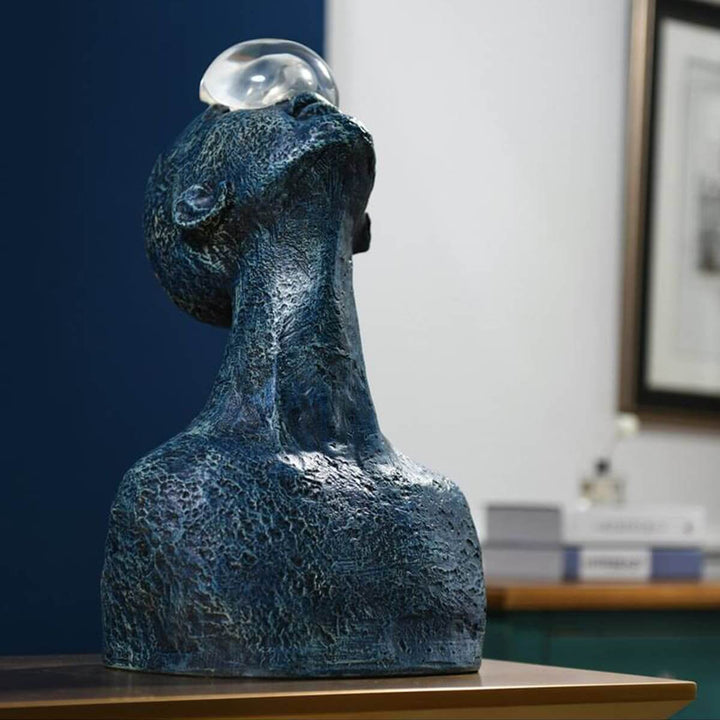 Zoreva resin sculpture featuring a blue textured bust with a clear orb, ideal for living room art deco decor.