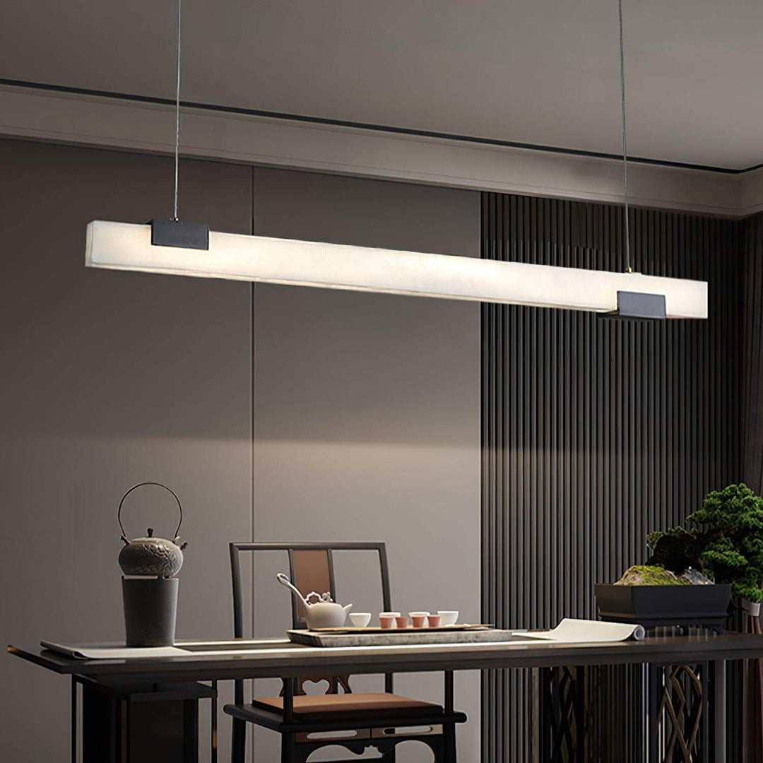 Cary Alabaster Pendant Light over dining table, modern linear design for contemporary kitchen island lighting.