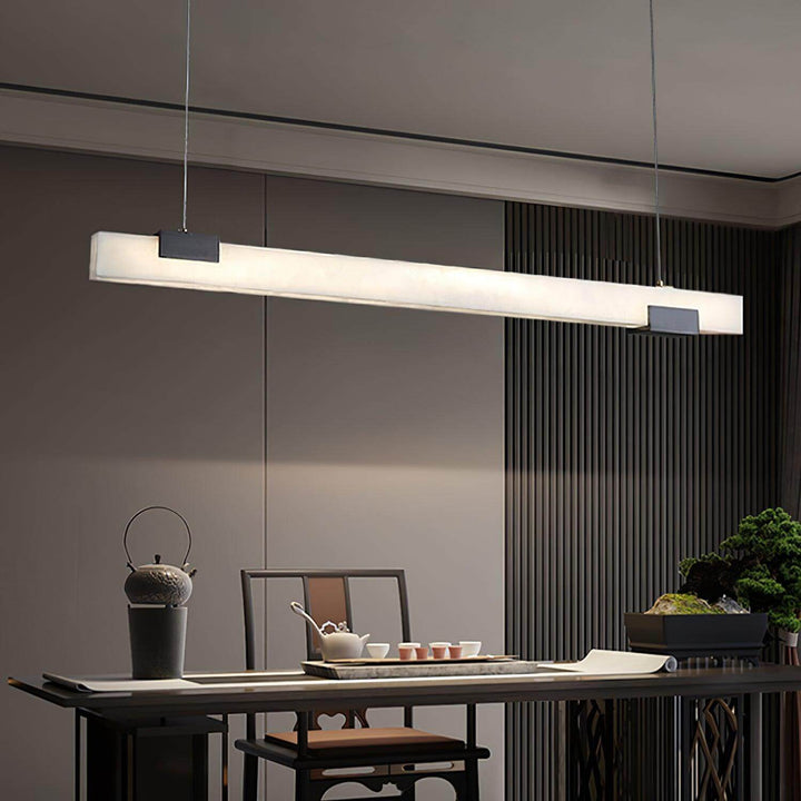Cary Alabaster Pendant Light over dining table, modern linear design for contemporary kitchen island lighting.