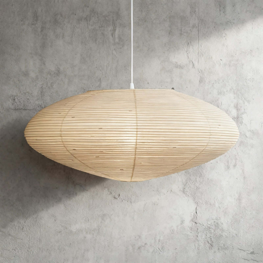 95A washi paper pendant light with a white wire against a gray wall.