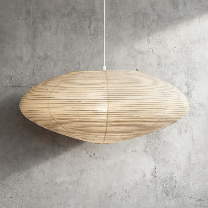 95A washi paper pendant light with a white wire against a gray wall.