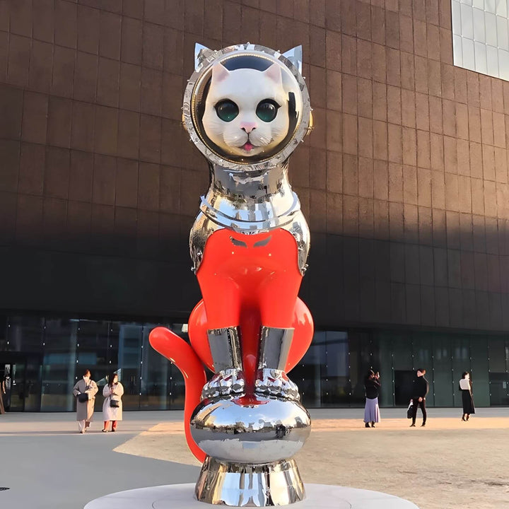 Colorful cat sculpture in astronaut outfit, art installation with metallic and vibrant elements.