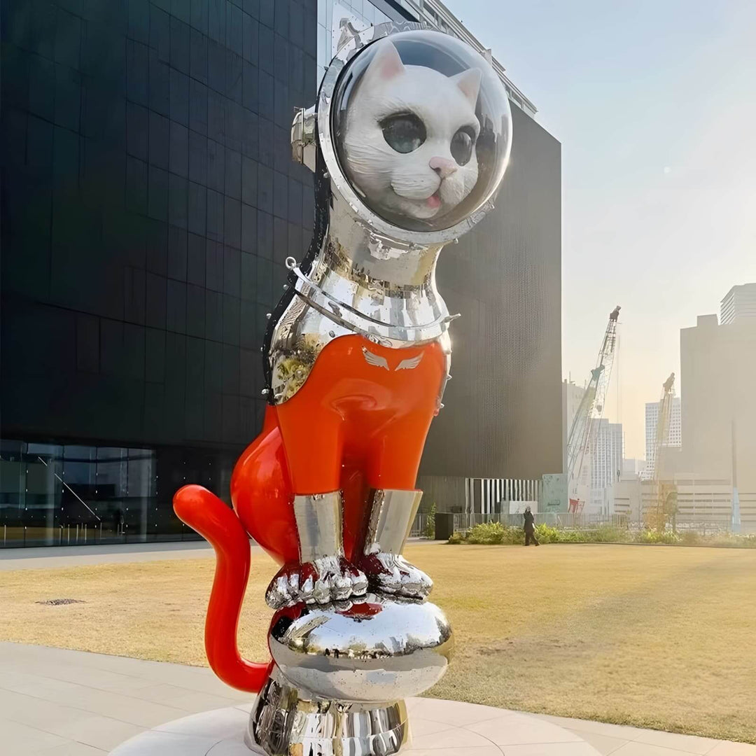 Cat sculpture in astronaut suit, showcasing innovative art in an outdoor urban setting.