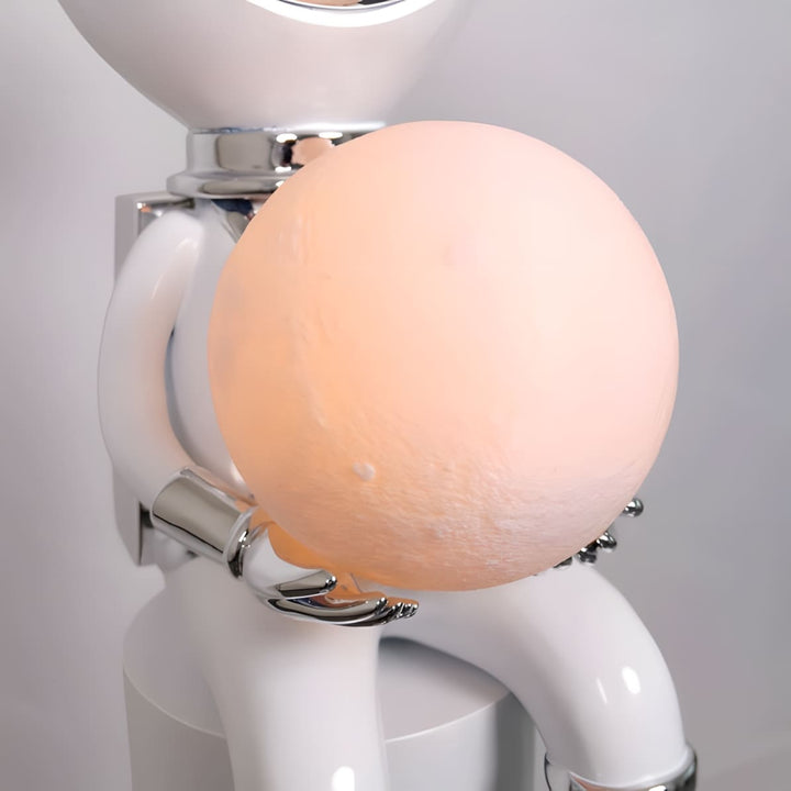 Sculptural lamp with a character holding a moon-shaped light, perfect for modern decor.