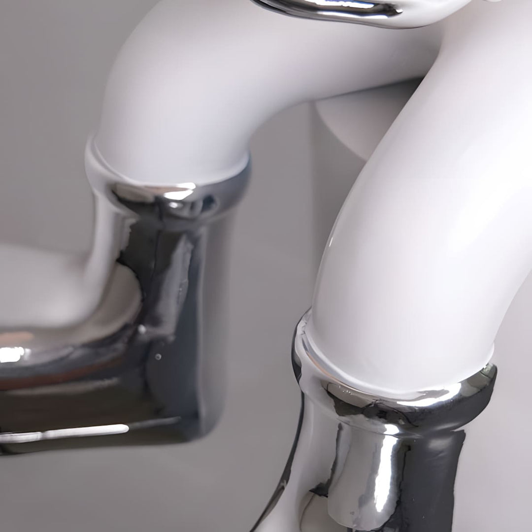 Close-up of stylish white sculpture legs with chrome detailing, perfect for contemporary decor.