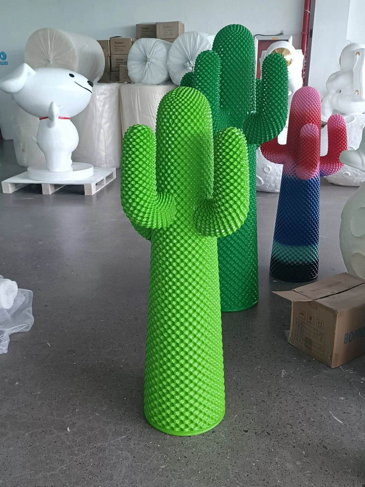 Colorful cactus sculptures in vibrant green and pink, perfect as sculptural floor lamps for modern living spaces.