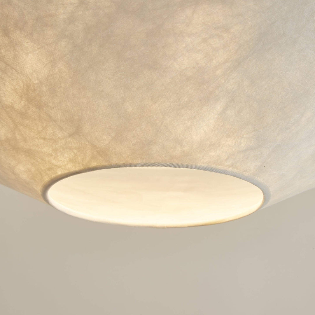 Close-up of the glowing bottom diffuser on the floating pendant light.