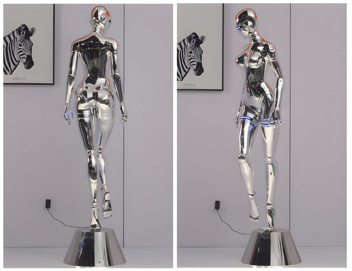 Sculptural silver floor lamp resembling a mannequin, perfect for trendy living room decor in art deco style.