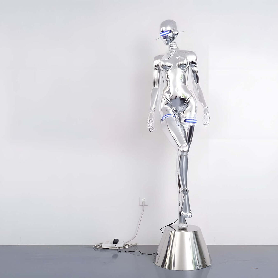 Sculptural floor lamp in a sleek silver finish, ideal for modern and art deco living room decor.