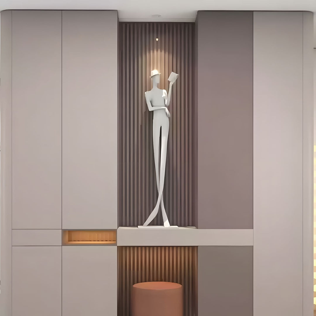 Sculptural floor lamp showcasing an art deco design with a figure reading, perfect for stylish living room lighting.