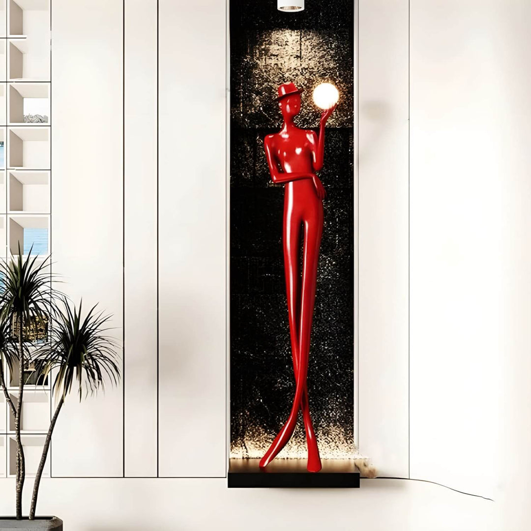 Sculptural floor lamp in red, an art deco design, adding elegance to living room decor.