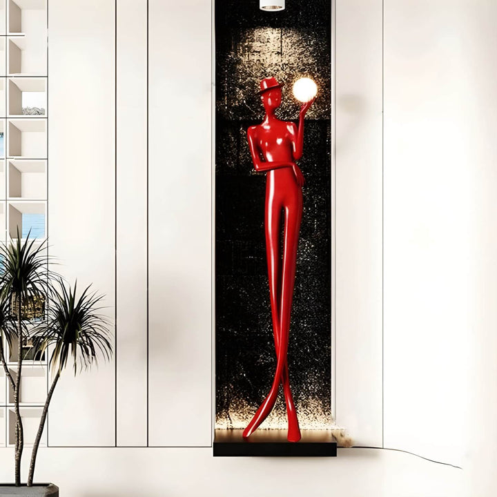 Sculptural floor lamp in red, an art deco design, adding elegance to living room decor.