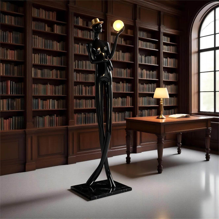 Sculptural floor lamp in art deco style, featuring a figure holding a globe light, perfect for living room decor.