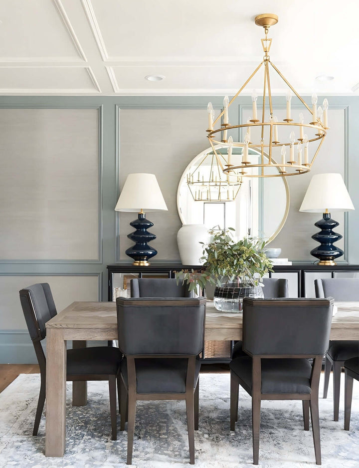 Luvo Serin chandelier in modern dining room with stylish black chairs and decorative lamps.