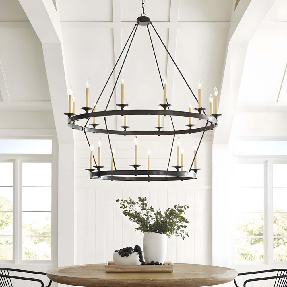 Luvo Serin Chandelier in dining room, featuring 12-light modern design with black finish and candle-style bulbs.